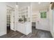 Mud room and dog wash with white cabinets, utility sink, and tile floors at 275 Pineland Nw Rd, Atlanta, GA 30342