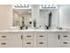 Double vanity bathroom with modern fixtures and large mirrors at 2705 Baker Ridge Nw Dr, Atlanta, GA 30318