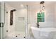 Bathroom with walk-in shower, soaking tub, and modern lighting at 2705 Baker Ridge Nw Dr, Atlanta, GA 30318