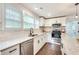 Bright kitchen boasts white cabinets, granite counters, and stainless steel appliances at 2705 Baker Ridge Nw Dr, Atlanta, GA 30318