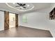 Main bedroom with barn door entry to ensuite bathroom and hardwood floors at 2705 Baker Ridge Nw Dr, Atlanta, GA 30318