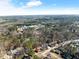 Aerial view of property and surrounding area, showing nearby businesses and residential homes at 5737 Riverside Dr, Sugar Hill, GA 30518