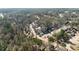 Aerial view of neighborhood, highlighting tree-lined streets and residential homes at 5737 Riverside Dr, Sugar Hill, GA 30518