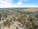 Aerial view of a neighborhood with a lake in the distance at 5737 Riverside Dr, Sugar Hill, GA 30518