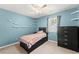 Bedroom with twin bed, built-in shelving, and ceiling fan at 5737 Riverside Dr, Sugar Hill, GA 30518