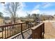 Wooden deck with seating area, offering a relaxing view of the neighborhood at 5737 Riverside Dr, Sugar Hill, GA 30518