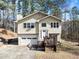 Tan two-story house with attached garage and deck at 5737 Riverside Dr, Sugar Hill, GA 30518