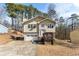 Tan two-story house with attached garage and deck at 5737 Riverside Dr, Sugar Hill, GA 30518