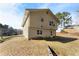 Back of house, two-story, light beige siding, and a small yard at 5737 Riverside Dr, Sugar Hill, GA 30518