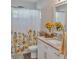 Bathroom with a bright sunflower shower curtain, white vanity, granite countertop, and fresh decor at 6460 Boca Grande Blvd, Forest Park, GA 30297