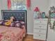 Bedroom featuring a bejeweled headboard, floral bedding, and a white dresser at 6460 Boca Grande Blvd, Forest Park, GA 30297