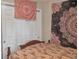 Bedroom featuring patterned wall tapestries over a dark wood bed at 6460 Boca Grande Blvd, Forest Park, GA 30297