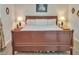 This cozy bedroom features a warm, wooden bed frame, complemented by soft lighting for a serene ambiance at 6460 Boca Grande Blvd, Forest Park, GA 30297