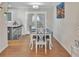 Bright dining area features a modern light fixture, an adjacent island, and access to the backyard at 6460 Boca Grande Blvd, Forest Park, GA 30297