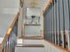 View of the entryway with hardwood steps, black metal railings, and decorative mirror at 6460 Boca Grande Blvd, Forest Park, GA 30297