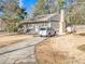 Charming single-Gathering home featuring neutral siding, chimney, and an asphalt driveway at 6460 Boca Grande Blvd, Forest Park, GA 30297