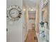 Bright hallway with a decorative mirror, wall clock, and hardwood flooring leading to other rooms at 6460 Boca Grande Blvd, Forest Park, GA 30297