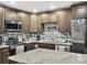 Updated kitchen featuring gray cabinets and granite island at 6460 Boca Grande Blvd, Forest Park, GA 30297