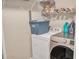 Well-lit laundry room with washer, dryer, and shelving for storage at 6460 Boca Grande Blvd, Forest Park, GA 30297