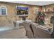 Inviting living room featuring a stone wall, flat screen television, and festive Christmas decor at 6460 Boca Grande Blvd, Forest Park, GA 30297