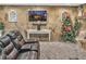 Relaxing living room featuring a stone wall with a sleek TV and comfortable seating for relaxation and entertainment at 6460 Boca Grande Blvd, Forest Park, GA 30297