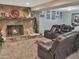 Cozy living room featuring a stone fireplace and comfortable leather seating for relaxing and entertaining at 6460 Boca Grande Blvd, Forest Park, GA 30297