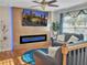 Inviting living room featuring an electric fireplace, ceiling fan, and large screen tv at 6460 Boca Grande Blvd, Forest Park, GA 30297