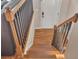 Hardwood staircase with oak railings and black spindles leading to the main floor at 6460 Boca Grande Blvd, Forest Park, GA 30297