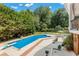 Relaxing pool area with patio furniture and lush landscaping at 1195 Old Woodbine Rd, Atlanta, GA 30319