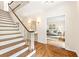 Elegant hardwood staircase with white railing and view of living room at 1195 Old Woodbine Rd, Atlanta, GA 30319