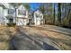 Townhouse exterior with two-car garage and wooded backdrop at 3654 Woodland Cv, Decatur, GA 30034