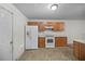 Kitchen with white appliances and wood cabinets at 3654 Woodland Cv, Decatur, GA 30034