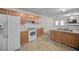 Kitchen features white appliances and wood cabinets at 3654 Woodland Cv, Decatur, GA 30034