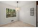 Bright dining room with chandelier and hardwood floors at 4086 Pecan Nw Ct, Lilburn, GA 30047