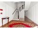 Entryway with staircase, red rug, and small table at 4143 N Swann St, Covington, GA 30014