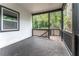 Spacious back porch with wooden railings overlooking a wooded backyard at 2711 Glenwood Se Ave, Atlanta, GA 30317