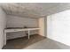Unfinished basement area with a workbench and white brick walls at 2711 Glenwood Se Ave, Atlanta, GA 30317