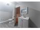 Modern bathroom featuring a toilet, vanity, and access to another room at 2711 Glenwood Se Ave, Atlanta, GA 30317