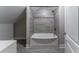 Updated bathroom with gray tile, tub shower combo, and white vanity at 2711 Glenwood Se Ave, Atlanta, GA 30317