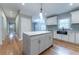 Modern kitchen island with white cabinets and granite countertop at 2711 Glenwood Se Ave, Atlanta, GA 30317