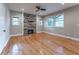 Bright living room featuring a ceiling fan and stylish fireplace wall and several windows at 2711 Glenwood Se Ave, Atlanta, GA 30317