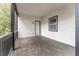 Spacious outdoor porch with railing and a white door and window for natural lighting at 2711 Glenwood Se Ave, Atlanta, GA 30317