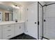 Bathroom boasts a white vanity, hexagon tile, and glass shower at 261 Dahlia Dr, Woodstock, GA 30188