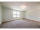 Empty bedroom features a carpeted floor and a bright window at 261 Dahlia Dr, Woodstock, GA 30188