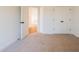 Bedroom showcasing neutral carpet, white walls, and open closet space at 261 Dahlia Dr, Woodstock, GA 30188