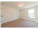 Cozy bedroom with neutral carpet, a window letting in natural light, and freshly painted walls at 261 Dahlia Dr, Woodstock, GA 30188