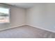 Simple bedroom with neutral walls, carpet, and window at 261 Dahlia Dr, Woodstock, GA 30188