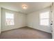 Bright bedroom with neutral carpet and two windows at 261 Dahlia Dr, Woodstock, GA 30188