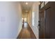 Welcoming home entryway with hardwood floors, neutral paint, and natural light streaming from windows at 261 Dahlia Dr, Woodstock, GA 30188