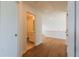 Upstairs hallway with hardwood floors leading to a bathroom at 261 Dahlia Dr, Woodstock, GA 30188